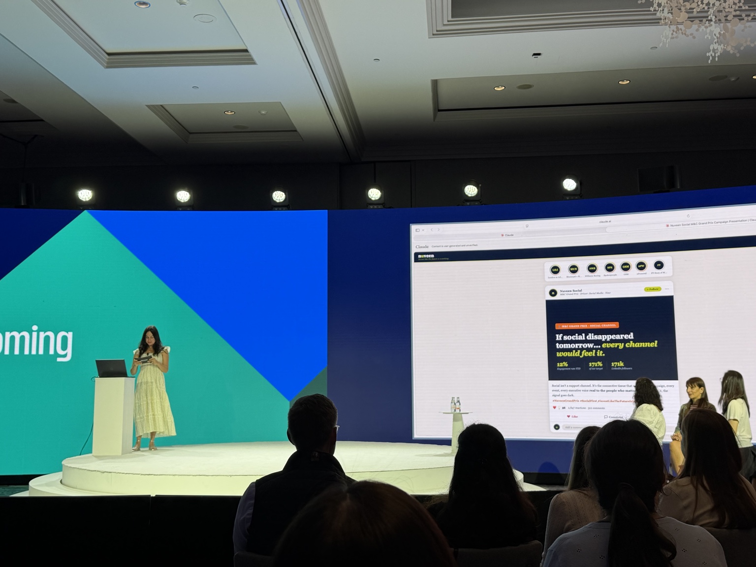 Eliana speaking on stage at a professional event
